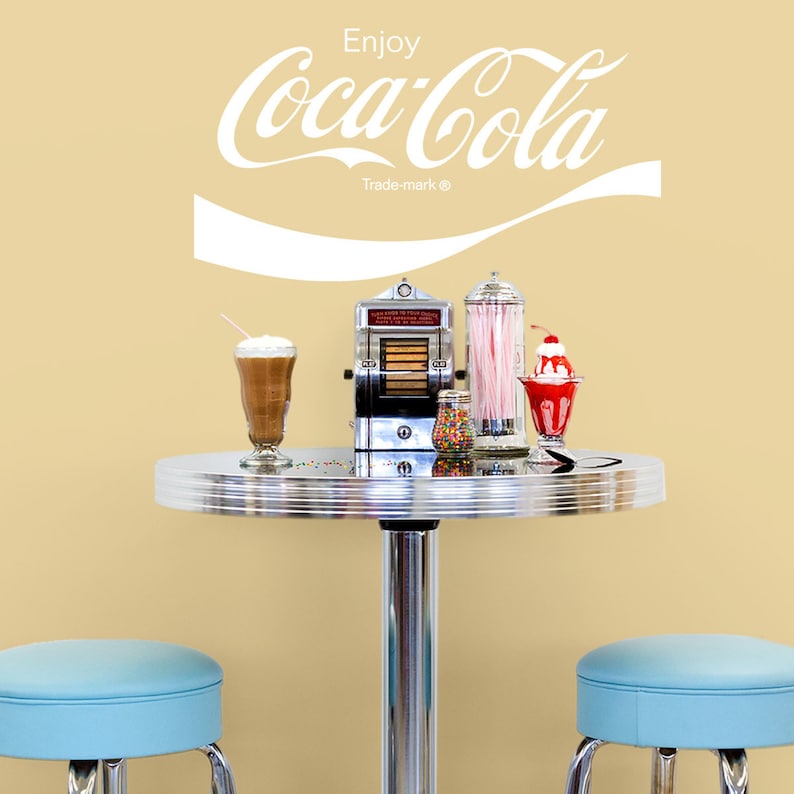 Enjoy Coca-Cola 1970s Script Vinyl Wall Decal is available in Red or White Colored Vinyl. Shown here in a diner settings.