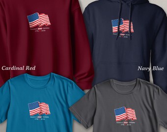 May include: Four different colored shirts and sweatshirts are displayed, each with a front print of the American flag and the text "America's 250th Birthday 1776-2026." Colors include cardinal red, navy blue, sapphire, and charcoal.
