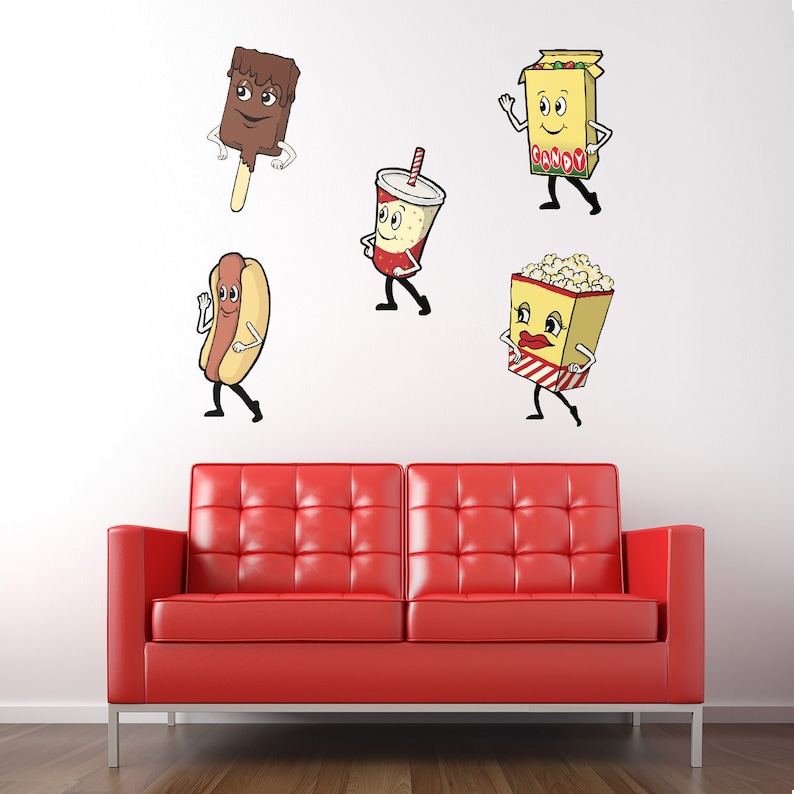 May include: Five cartoon food characters on a white wall above a red couch. The characters are a hot dog, a chocolate bar, a soda, a popcorn bucket, and a box of candy. Each character has a face and arms and legs.