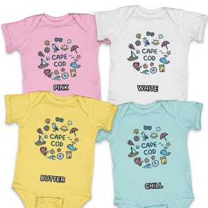 May include: Four baby onesies in pink, white, yellow, and light blue. Each onesie features a circular graphic with nautical elements and the text "CAPE COD". The onesies are short-sleeved and have a simple design.