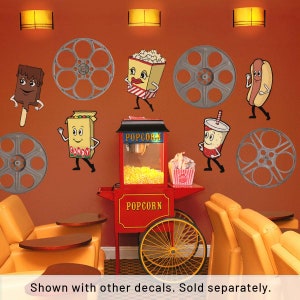 May include: A red and yellow popcorn machine with a sign that says "Popcorn" on it. There are five cartoon characters on the wall, including a hot dog, a popcorn bucket, a candy box, a soda cup, and an ice cream bar. There are also five film reels on the wall. The characters are all smiling and waving.