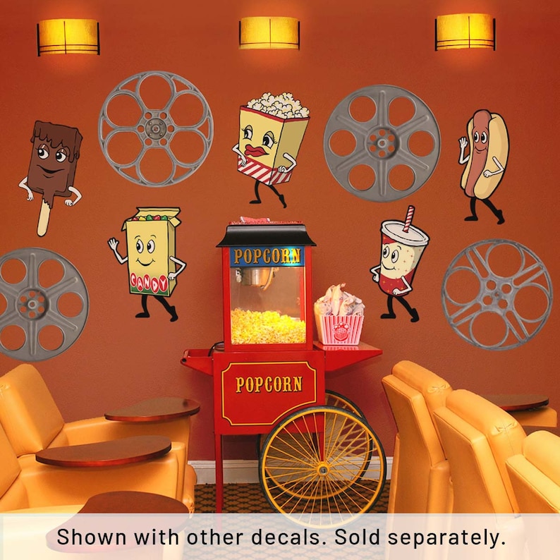 May include: A red and yellow popcorn machine with a sign that says "Popcorn" on it. There are five cartoon characters on the wall, including a hot dog, a popcorn bucket, a candy box, a soda cup, and an ice cream bar. There are also five film reels on the wall. The characters are all smiling and waving.