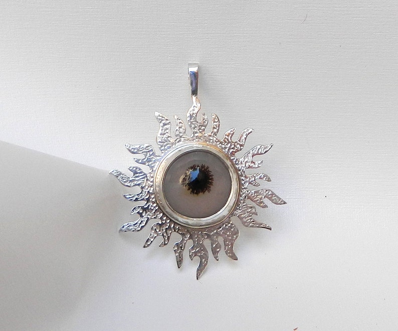 Sterling silver artisan pendant with solar quartz gemstone, protects against evil eye and purifies the soul