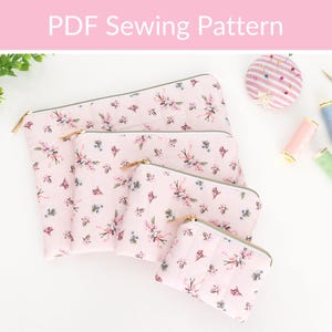 May include: A set of four quilted zipper pouches in graduated sizes, featuring a light pink fabric with a floral pattern of small pink and blue flowers. Each pouch has a gold-tone zipper closure. The image includes the text PDF Sewing Pattern.