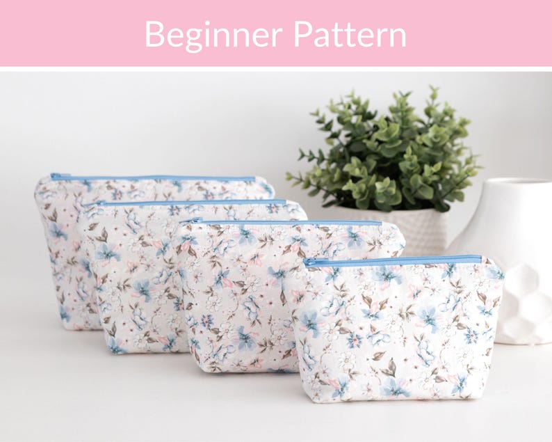 Four beginner zip pouches in soft blue and pink floral fabric in graduated sizes, labelled as a beginner sewing pattern.