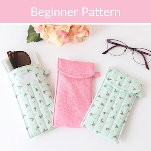 May include: Three rectangular fabric pouches for eyewear, including two light green cases with a small pink floral pattern and one solid pink case. The text "Beginner Pattern" is displayed at the top of the image above the pouches.