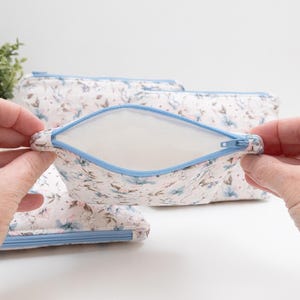 Beginner zip pouch held open to show the fully lined interior with no raw edges and a blue zip.
