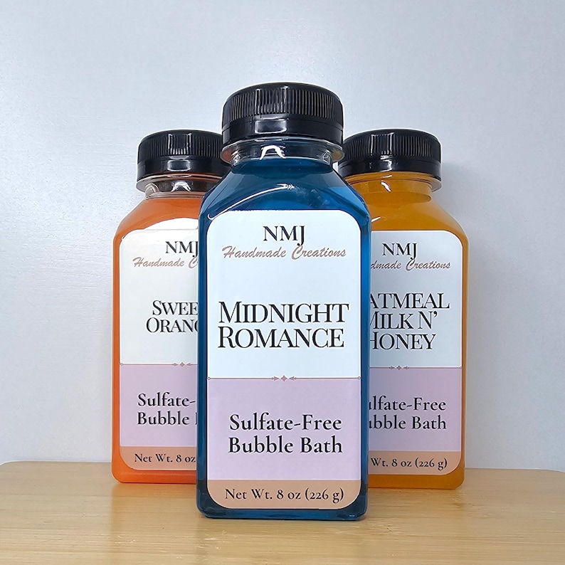 May include: Three bottles of sulfate-free bubble bath in orange, blue, and yellow. The labels read "Sweet Orange", "Midnight Romance", and "Oatmeal Milk 'N Honey". Each bottle is 226 g.