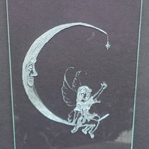 Fairy reaching for the star with the man in the moon. Detailed hand engraved/carved on window glass. Precious treasure for any age.