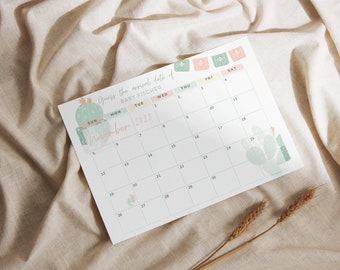 May include: A white calendar with a cactus theme, featuring the text "Guess the arrival date of BABY FISCHER" and "November 2023." The calendar has a grid layout with dates and days of the week, and decorative cactus illustrations.