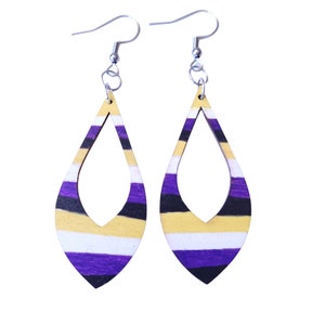 May include: A pair of teardrop-shaped earrings with a striped design in purple, yellow, white, and black. The earrings have a silver hook closure.