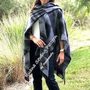 May include: A black and gray patterned poncho with fringe. The poncho is worn over a white shirt and blue jeans. The text "Rhuana Sewing Pattern by itsssewSally" is visible on the poncho.