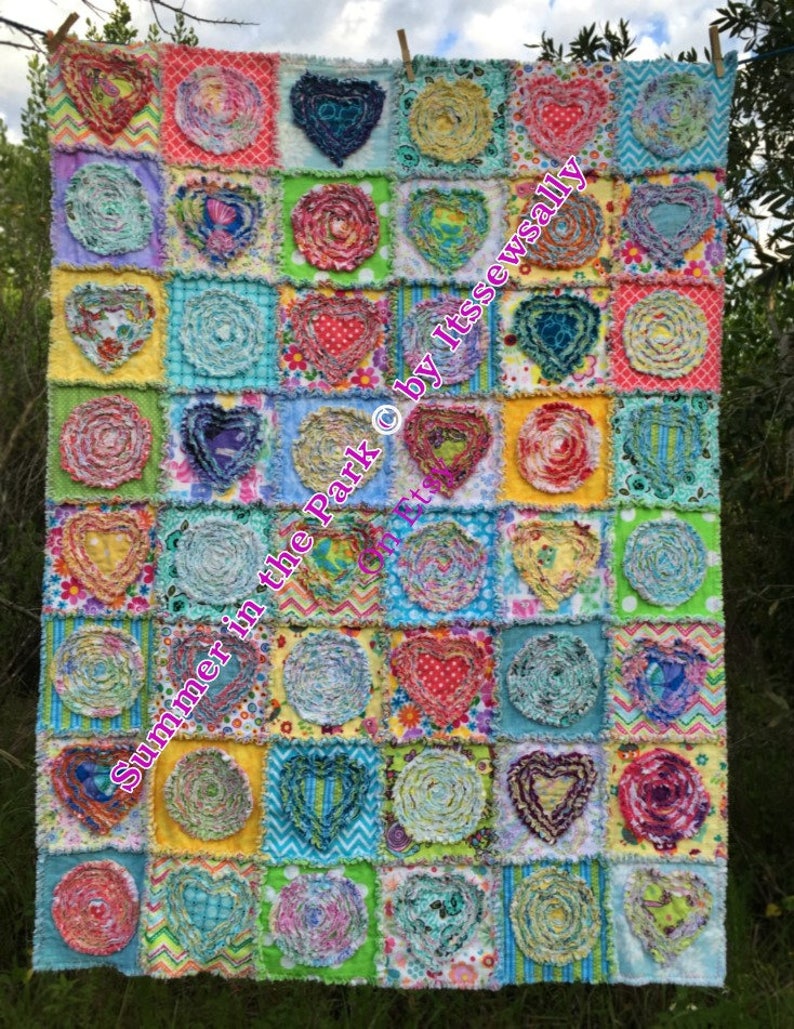 Puede incluir: Una colcha colorida con un dise&ntilde;o de patchwork que presenta varios tonos de amarillo, verde, azul, rosa y rojo. La colcha est&aacute; hecha de cuadrados con diferentes patrones, incluyendo corazones, remolinos y lunares. El texto "Summer in the Park &copy; by ItssewSally Etsy" est&aacute; escrito en rosa en la colcha.
