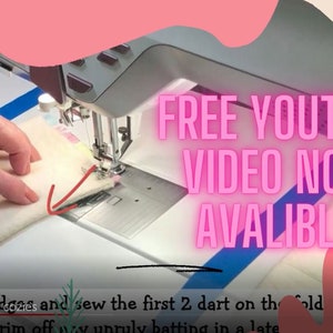 May include: A close-up of a person's hand sewing fabric on a sewing machine. The image has a colorful background with the text "FREE YOUTUBE VIDEO NOW AVAILABLE!" in pink.