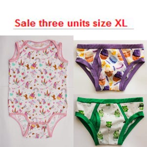 May include: A white baby bodysuit with a pink trim and a pattern of unicorns, cupcakes, and rainbows. Two pairs of underwear are also shown, one with a cupcake pattern and purple trim, and the other with a cactus pattern and green trim.