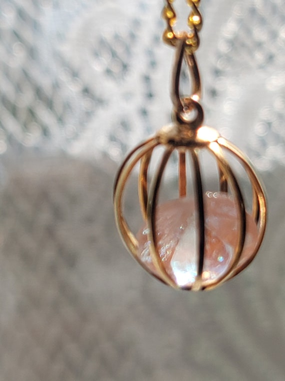 Trapped Saphiret in gold cage necklace pendant