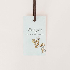 May include: A light blue thank you tag with a bee and a branch of yellow flowers. The tag says "Thank you! Love Annabelle".