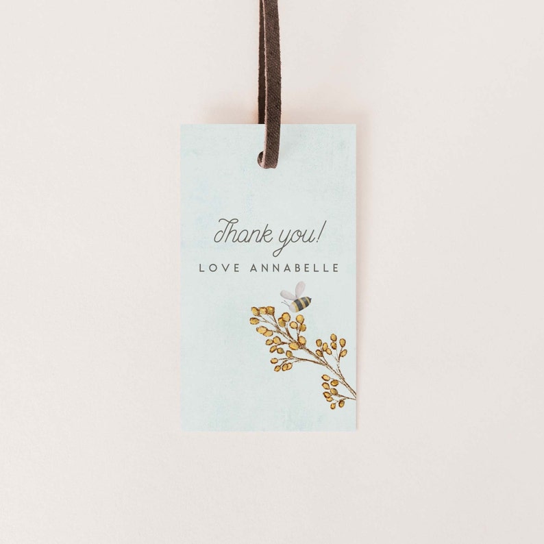 May include: A light blue thank you tag with a bee and a branch of yellow flowers. The tag says "Thank you! Love Annabelle".