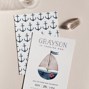 May include: A nautical-themed birthday invitation for a boy named Grayson turning one. The invitation features a watercolour illustration of a sailboat with a red life preserver. The invitation is decorated with a pattern of anchors.