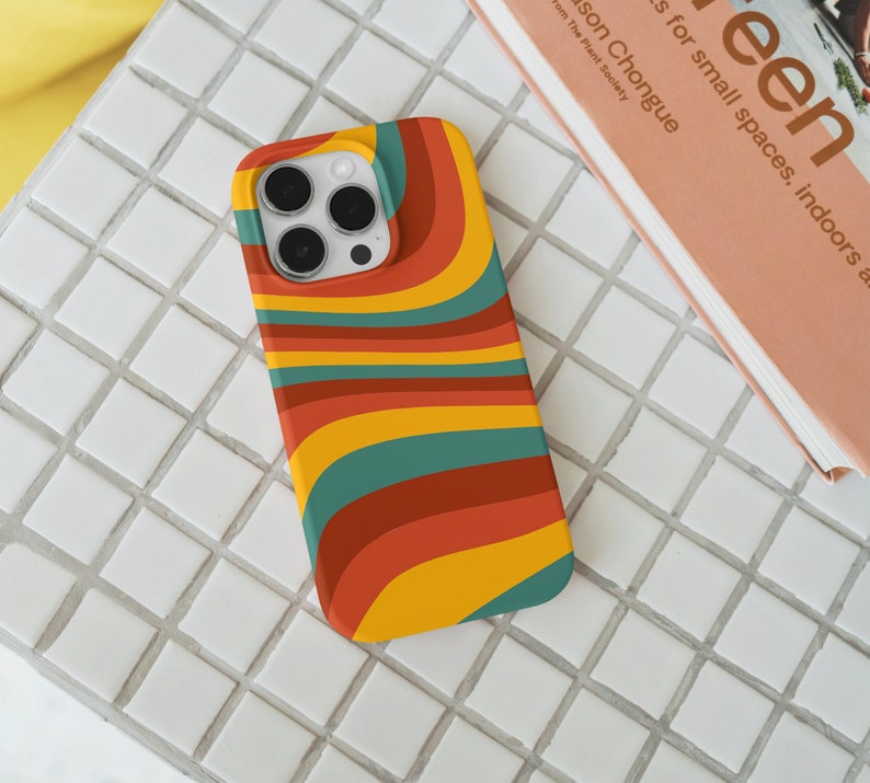 May include: A phone case with a colorful abstract design featuring wavy lines in shades of yellow, orange, red, green, and blue.