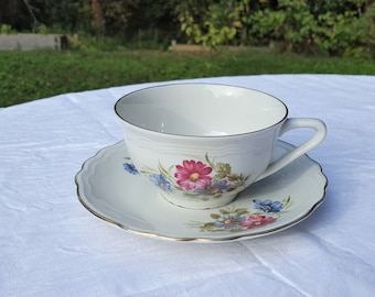 French vintage white porcelain coffee cup or tea cup and saucer with rose floral decor