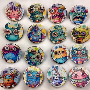 May include: A set of 15 colorful monster pins with various designs and colors. The pins are round and feature different monster characters with unique expressions and details. The pins are perfect for adding a fun and quirky touch to any bag, jacket, or hat.