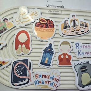 May include: A set of colorful stickers with Islamic themes, including a crescent moon, a lantern, a bowl of dates, and the phrases "Ramadan Kareem" and "Ramadan Mubarak".