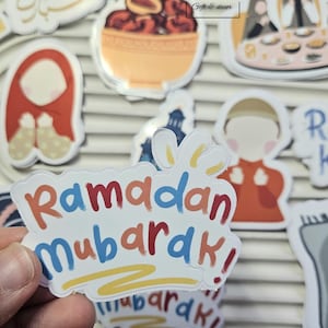 May include: A set of colorful stickers with a Ramadan Mubarak theme. The stickers feature illustrations of a woman in a headscarf, a bowl of dates, a mosque, and a family celebrating Ramadan. The stickers are perfect for adding a festive touch to your home or gifts.