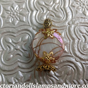 Miniature new perfume like bottle with gold like running though pinkish and white  for your doll house