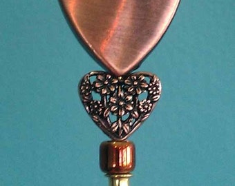 Hat Pin 6 inch gold finish stick with copper finish heart and lacey smaller heart with copper finsh beads with clutch on bottom of tip