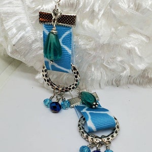 Czech fire polished beads, Glass beads, ribbon and a charm.