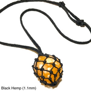 May include: A necklace featuring a spherical, orange-colored stone encased in a black woven net, suspended from a black hemp cord. The text "Black Hemp (1.1mm)" is visible at the bottom of the image.