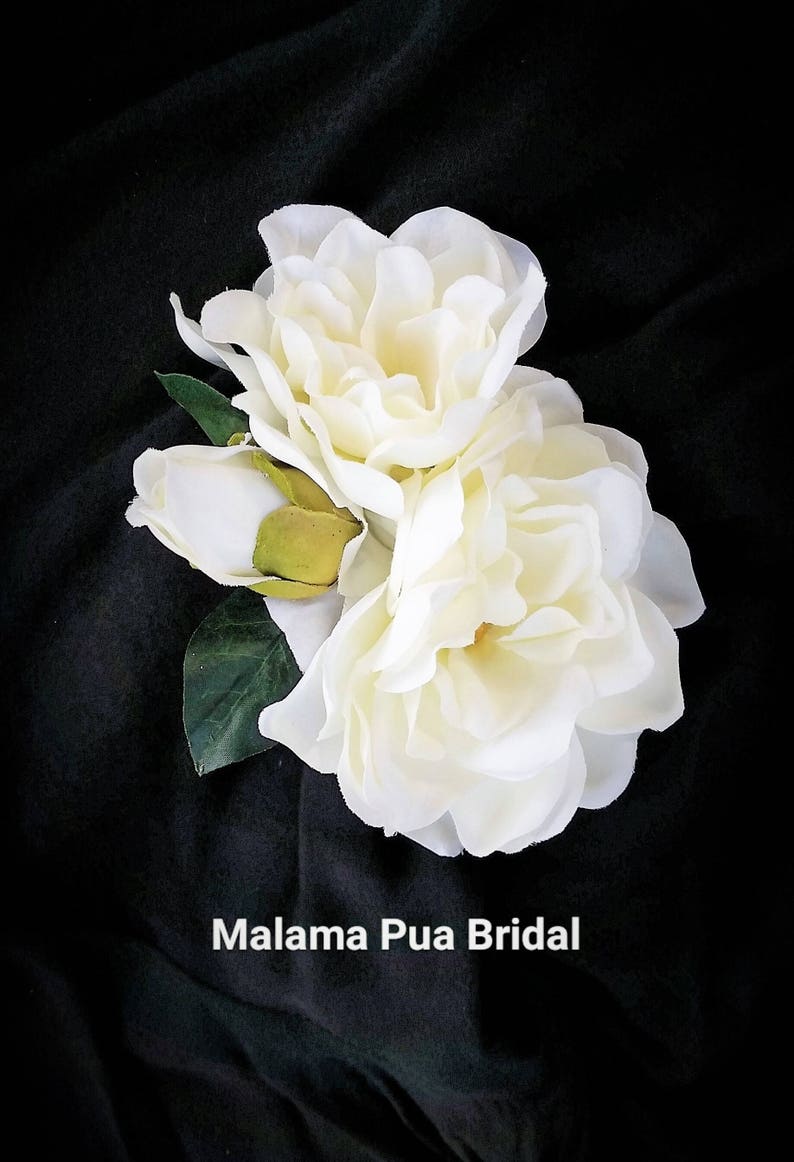 Beautiful bride wearing custom silk Gardenia Wedding headpiece by Malama Pua Bridal.  This hair accessory is a traditional classic Bridal Gardenia hair clip and is created with hand wired crystal center and completed with tropical green leaves.