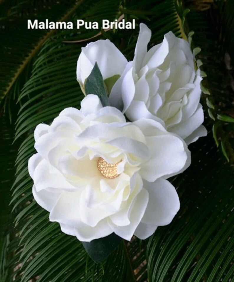 Custom silk Gardenia Wedding headpiece by Malama Pua Bridal.  This hair accessory is a traditional classic Bridal Gardenia hair clip and is created with hand wired crystal center and completed with tropical green leaves.