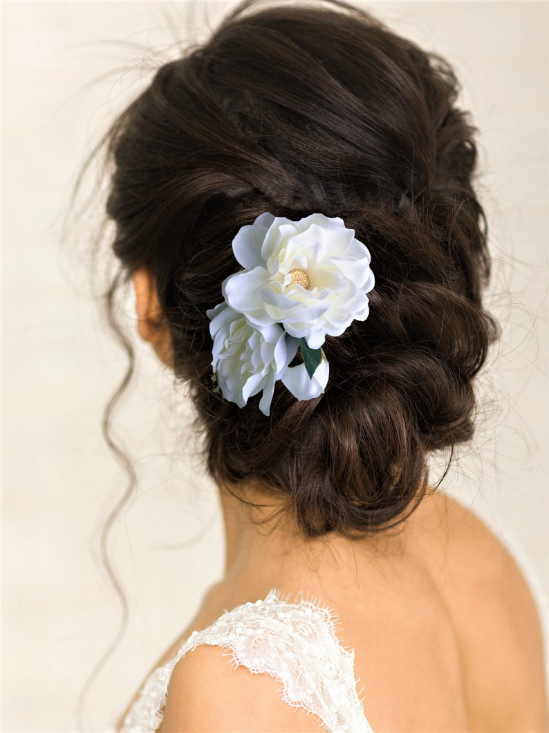 Beautiful bride wearing custom silk Gardenia Wedding headpiece by Malama Pua Bridal.  This hair accessory is a traditional classic Bridal Gardenia hair clip and is created with hand wired crystal center and completed with tropical green leaves.