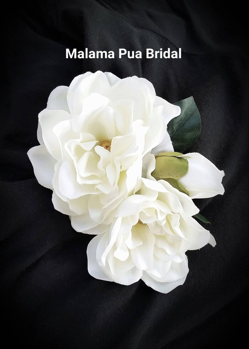 Custom silk Gardenia Wedding headpiece by Malama Pua Bridal.  This hair accessory is a traditional classic Bridal Gardenia hair clip and is created with hand wired crystal center and completed with tropical green leaves.