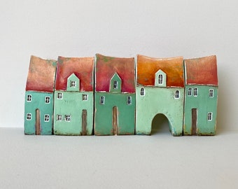 A set of five rustic turquoise shaded houses  in a row