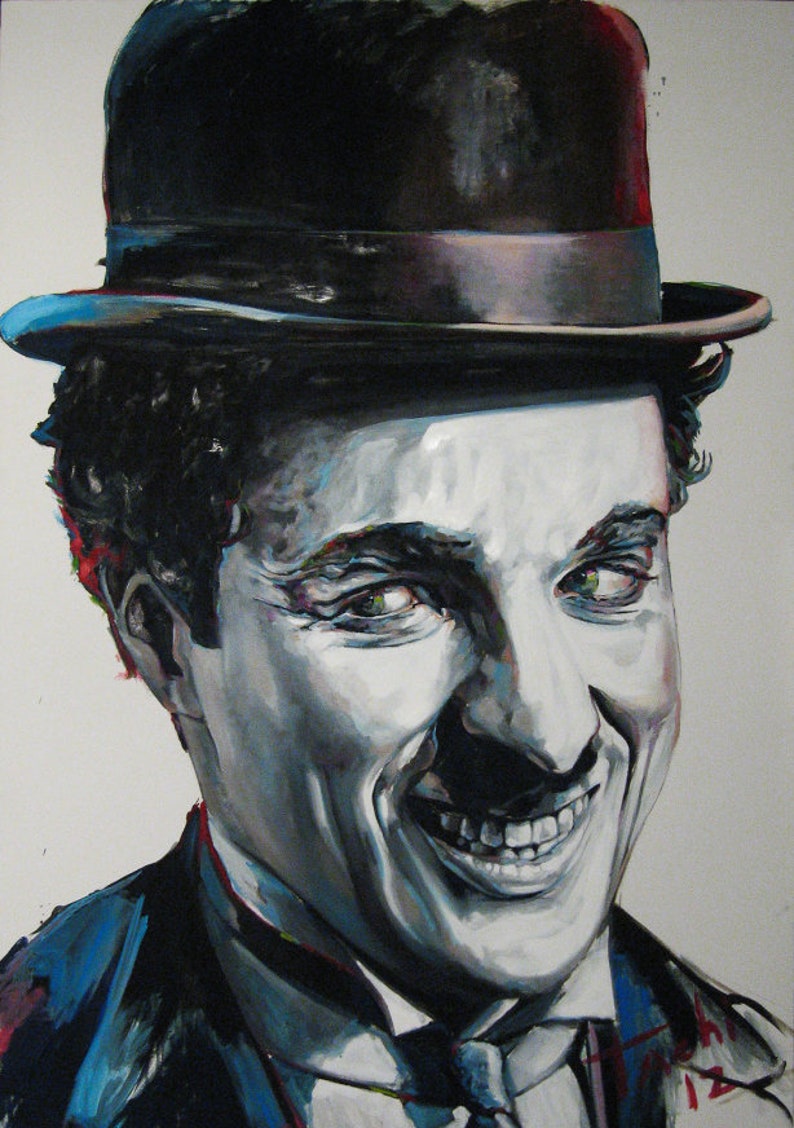May include: A painted portrait of Charlie Chaplin, the iconic silent film actor. The artwork features Chaplin's smiling face, with a black bowler hat and a dark suit. The painting uses a grayscale palette with touches of color.