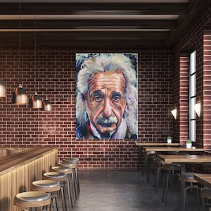 May include: An interior shot of a bar or restaurant with a large portrait of Albert Einstein on a brick wall. The room features wooden tables, stools, and copper-toned pendant lights, creating a warm, inviting atmosphere.
