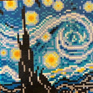 May include: A pixelated artwork depicting Van Gogh's "Starry Night." The piece features a swirling sky in shades of blue, with yellow stars and a crescent moon. A dark, silhouetted town is at the bottom, with a tall, dark structure on the left.