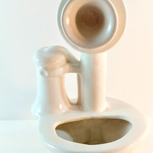 May include: White ceramic planter shaped like an old-fashioned phone with a green base and a yellow accent.