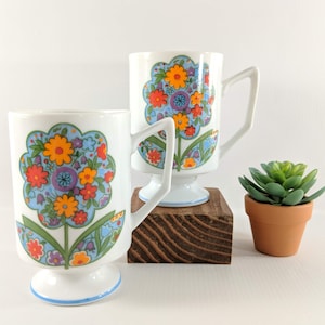Vtg. Flower Power Pedestal Coffee Cups. Set of 2 White Mugs with Multicolored Daisies. 1970&#39;s, Retro, Mod Kitchen. Made in Japan.