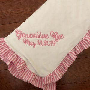 Embroidered pink ruffle baby blanket with name and date