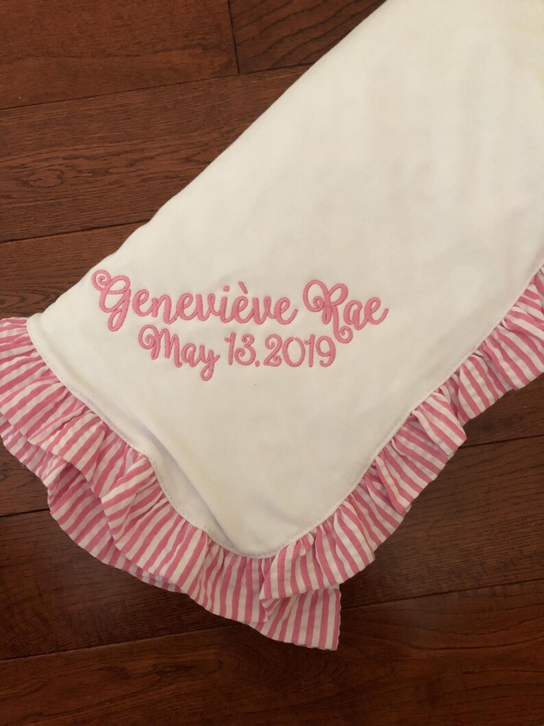 Embroidered pink ruffle baby blanket with name and date