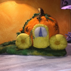 This is the Cinderella carriage, a pumpkin, in carded,fairy wool. In style Waldorf.