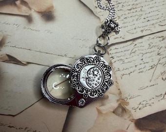 Jewelers Loupe necklace with a cute crescent moon charm. It hangs from a 30 inch curb chain. 30x21mm
