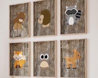 May include: Set of six framed woodland animal prints with a woodgrain background. The animals include a bear, hedgehog, raccoon, owl, deer, and fox.