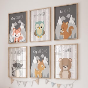 May include: Six framed art prints with woodland animal illustrations. Each print features a different animal, including a fox, owl, squirrel, raccoon, deer, and bear, with inspirational phrases like "Stay Clever" and "Be Kind" in gray text.
