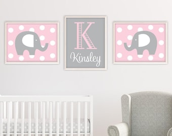 May include: Three framed prints with a pink and gray color scheme. The center print features a large pink letter K and the name Kinsley. The prints on either side feature a gray elephant with pink polka dots on a pink background.