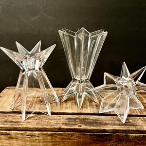May include: A set of three ceramic mugs with a speckled, matte finish. The mugs are in shades of cream, light gray, and dark gray. Each mug has a simple, modern design and a rounded handle. Perfect for coffee or tea.